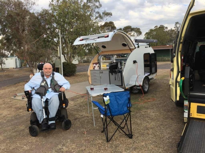 4619_peter_sitting_in_his_wheelchair_outside_the_trailer