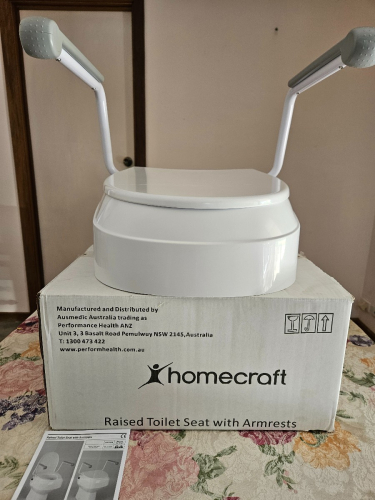 Raised toilet seat with Armrests by Homecraft